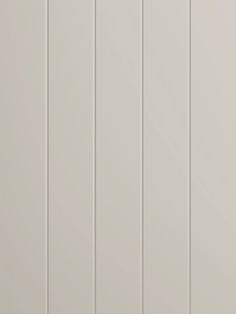 a white wall with vertical paneling on it