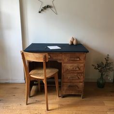 a wooden chair sitting next to a desk with a star on the wall above it