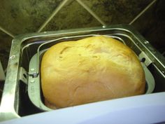 a loaf of bread sitting in a metal pan on top of a toaster oven