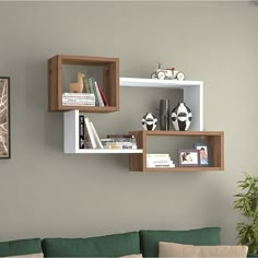 a living room filled with furniture next to a wall mounted book shelf on the wall