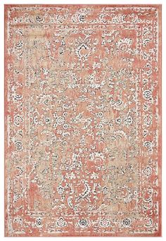 an orange and white rug with floral designs