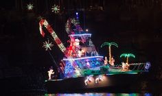 a boat decorated with christmas lights on the water