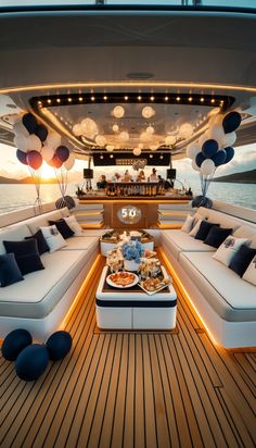 the inside of a boat with couches and balloons