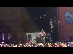 a man standing on top of a stage in front of a crowd