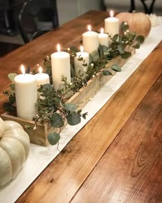 an instagram page with candles and pumpkins on the table in front of it