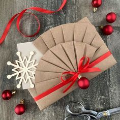 a brown paper fan sitting on top of a wooden table next to scissors and ornaments