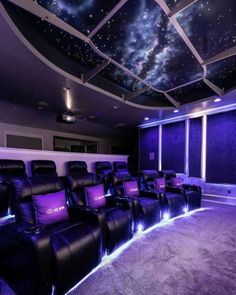 an empty theater with purple seats and stars on the ceiling