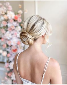 a woman with blonde hair in a low bun