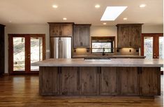 a large kitchen with wooden cabinets and stainless steel appliances