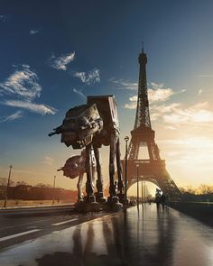 the eiffel tower is next to two star wars action figures in front of it