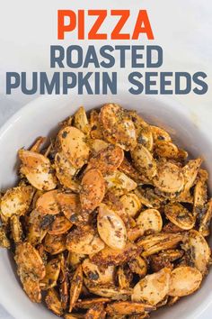 roasted pumpkin seeds in a white bowl with text overlay that reads pizza roasted pumpkin seeds