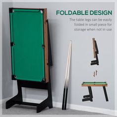 a pool table with two cues in front of it and an easel next to it