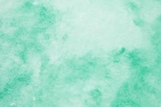 a green and white background with some watercolor stains on it's surface,