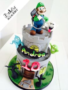 a birthday cake with an image of mario on top and other decorations around the base