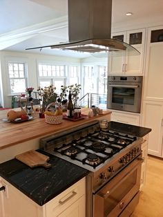 a kitchen with an oven, stove and counter top in the middle of the room