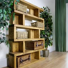 a wooden shelf with baskets and plants in it