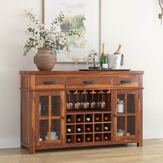 a wooden cabinet with wine glasses and bottles on it