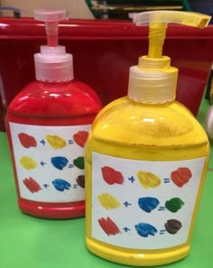 two hand soaps are sitting next to each other on a table with red and yellow containers