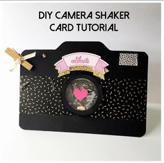 a black and white card with pink heart on it