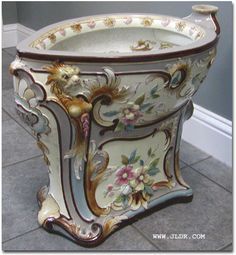 an ornately decorated toilet bowl on the floor