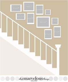 a stair case with many frames on the wall and below it is a white handrail