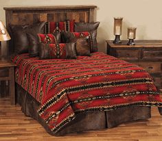 a bed with red and black bedspread in a bedroom next to two night stands