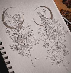 an open notebook with drawings of flowers and stars on the pages, next to a drawing book