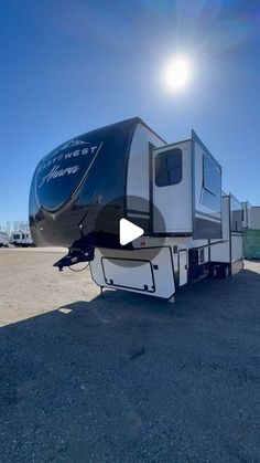 an rv parked in a parking lot with the sun shining on it