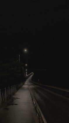 an empty street at night with the light on