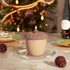 a cupcake sitting on top of a plate next to a bottle of wine