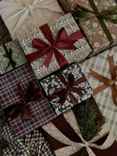 many wrapped presents with ribbons and bows on them