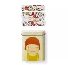 two tins with cartoon characters on them, one is white and the other has red hair