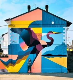 a man standing in front of a colorful building