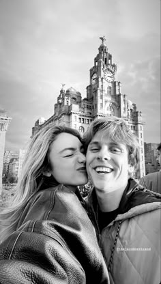 black and white photograph of two people in front of a castle