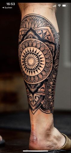 a man's leg with an intricate tattoo design on the side of his leg