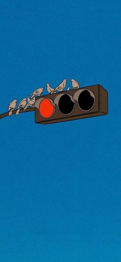 a traffic light with birds sitting on it's red lights and blue sky in the background