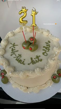 a birthday cake with two olives on it and the number twenty five in gold