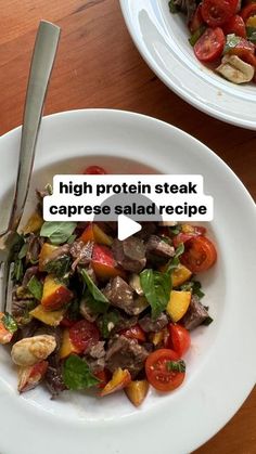 a white plate topped with meat and veggies next to a bowl of salad