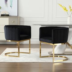 two black chairs sitting on top of a white rug