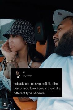 a man and woman sitting in the back seat of a car talking to each other