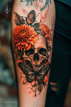 a woman's arm with a skull and flowers on it, which is decorated with butterflies