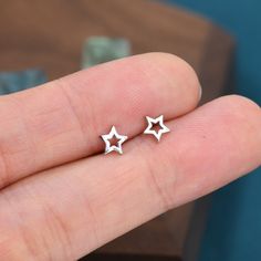 Sterling Silver Tiny Little Open Star Cutout Stud Earrings, Cute and Fun Jewellery. Tiny and Discreet, suitable for everyday wear.  Dimensions: 5mm x 5mm   Hand crafted by Silver Rain.  ★Free Shipping for UK orders, a flat postage fee applies to rest of world. One postage fee charged per order.★ ♥message us if you have any questions Facebook:  https://www.facebook.com/pages/Silver-Rain/1063191357028981?ref=hl Cute Earrings Studs, Cute Silver Earrings, Cute Stud Earrings, Cat Earrings Studs, Simple Hoop Earrings, Star Stud Earrings, Stud Earrings Silver, Stacked Earrings, Buy Earrings