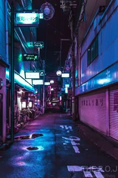 an alley way at night with neon lights