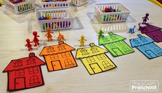 colorful paper houses and toy figures on a table