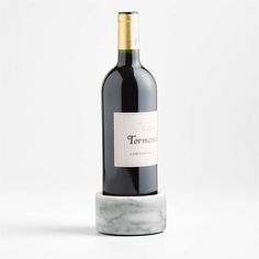 a bottle of wine sitting on top of a marble base