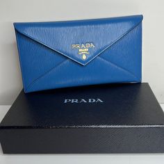 Just Purchased In Italy This Is A Gorgeous Prada Slim Envelope Wallet In Cobalt Blue Leather! Can Also Be Used As A Clutch. Stunning!!!!!! Gold Hardware. Fits Credit Cards And Perfect To Hold Cash Or Receipts. Has A Zip Pocket On The Back For Coins. Comes With Box And Authenticity Certificate. Makes A Gorgeous Gift! All Brand Brand New!! Super Pretty! Blue Is Even More Beautiful In Person. Designer Envelope Clutch For Travel, Designer Travel Envelope Clutch, Designer Blue Wallets For Business, Designer Blue Business Wallets, Formal Blue Bags With Card Slots, Designer Blue Bags With Card Slots, Blue Designer Bags With Card Slots, Luxury Blue Wallet For Formal Occasions, Designer Blue Wallet For Formal Occasions