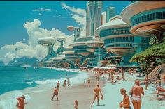 many people are on the beach in front of futuristic buildings