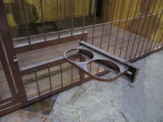 an iron gate and wooden floor in front of a jail cell