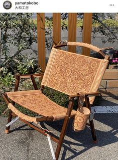 a wooden chair sitting on top of a sidewalk