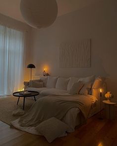 a bedroom with white walls and wooden floors